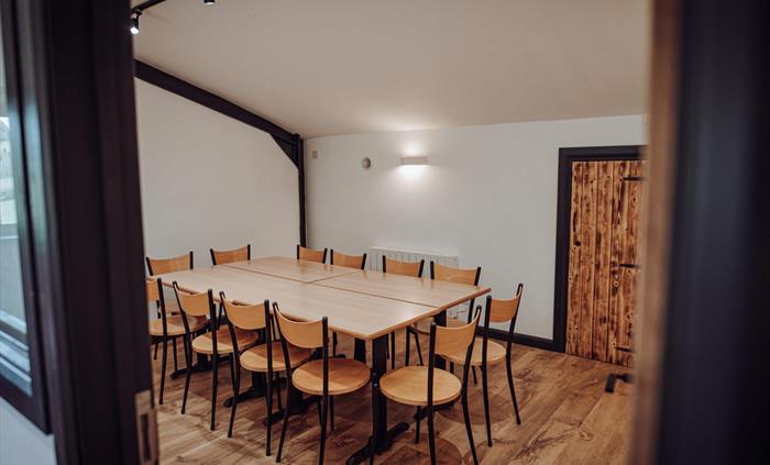 Smaller tables and chairs in a breakout room in the Grain Shed